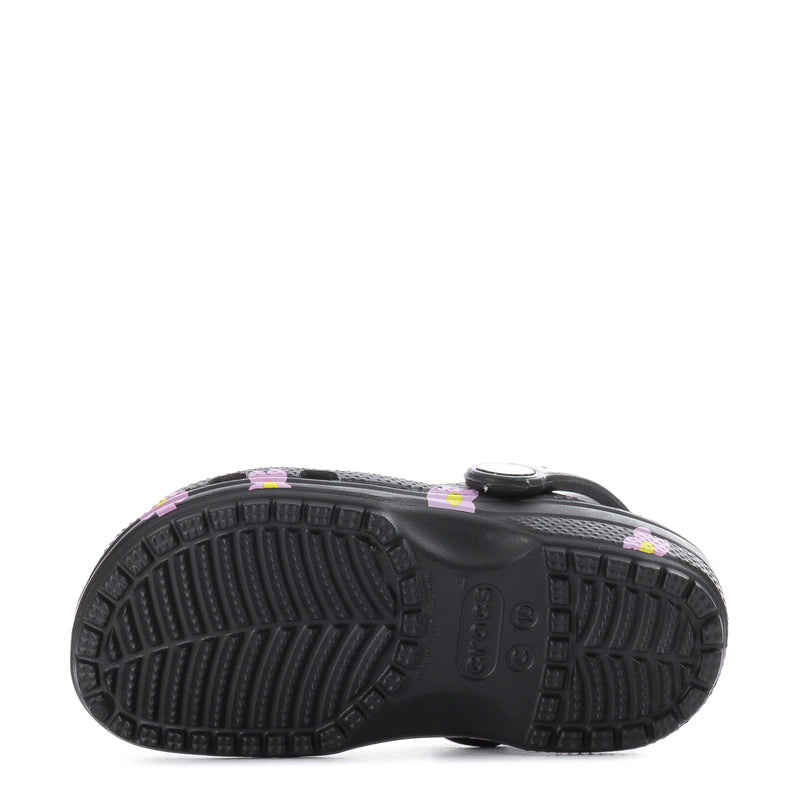 Toddler clog outsole tread on black bottom, pink flower uppers visible at sides