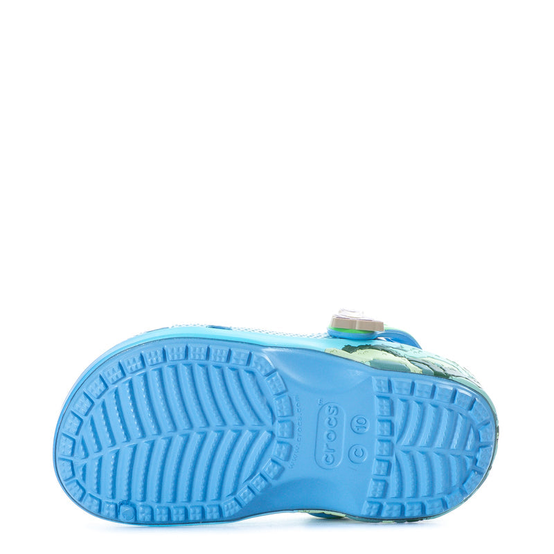 Toddler blue clog outsole with tread pattern and green heel detail.