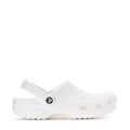 Youth white clog with vented upper and round logo patch, side profile.