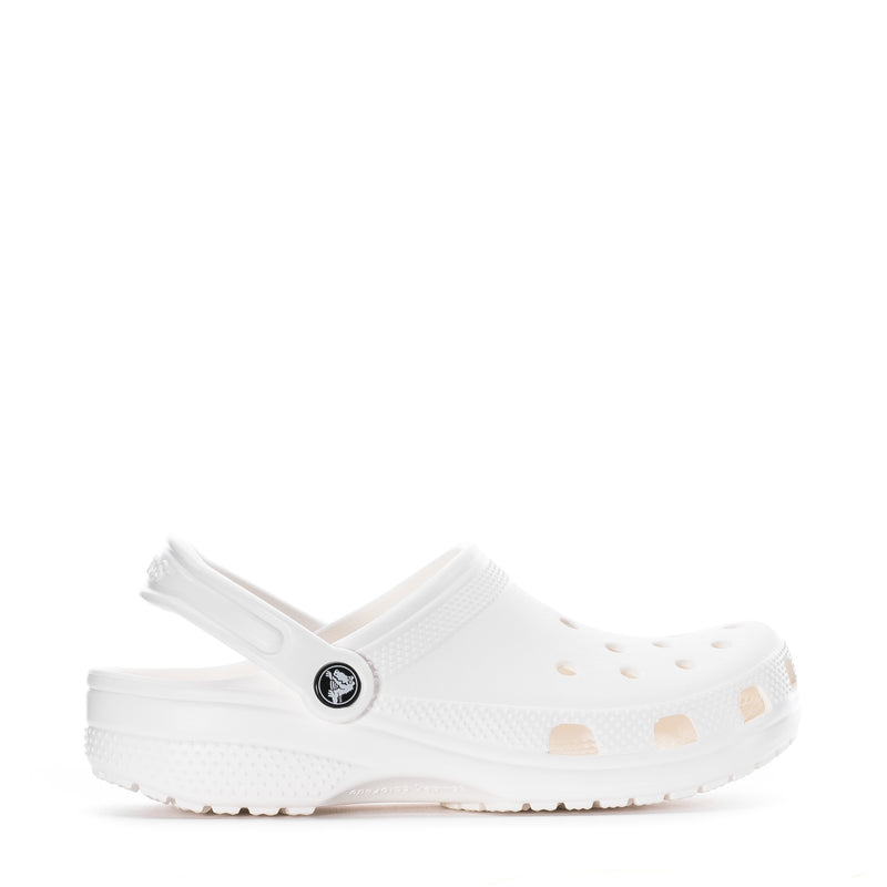 Youth white clog with vented upper and round logo patch, side profile.
