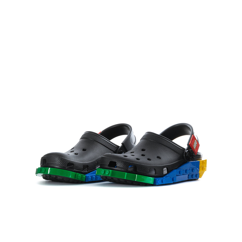 Youth clogs pair with black uppers and colorful base in green, blue, and yellow
