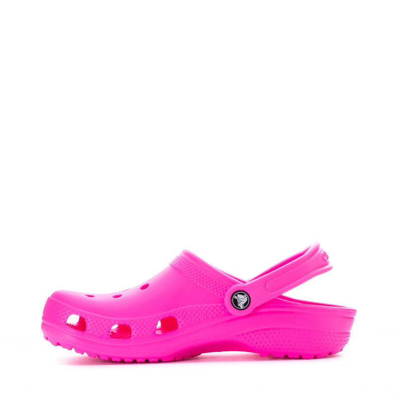 Youth Crocs classic clog in bright pink, side profile with vent holes
