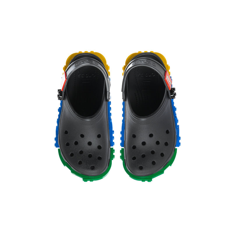 Youth clog shoes with black perforated uppers and colorful LEGO-style heel inserts