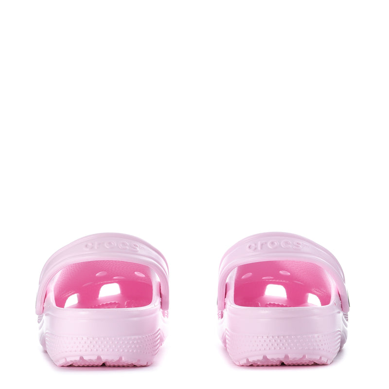 Light pink youth clogs showing back heel openings and treaded sole