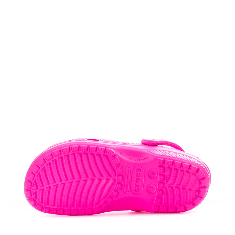 Youth Crocs classic clog in bright pink with textured rubber outsole tread