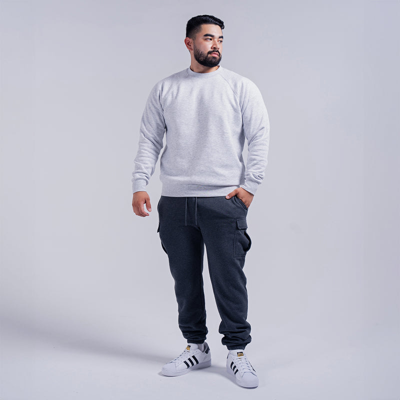 Men's heather grey fleece crewneck sweatshirt on model, straight hem, ribbed neckline