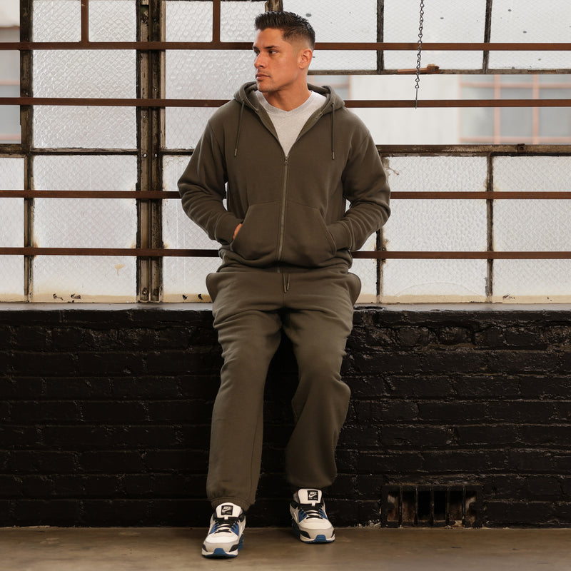 Men's olive fleece zip hoody on model with drawstring hood and front kangaroo pocket