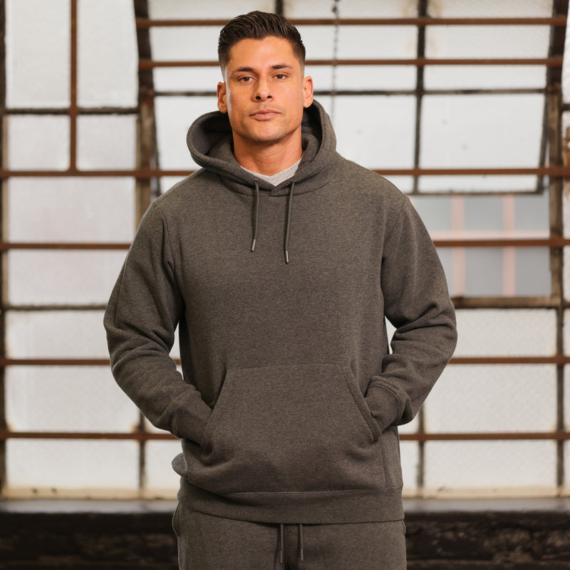Men's charcoal fleece pullover hoodie worn, standing front; hood with drawstrings.