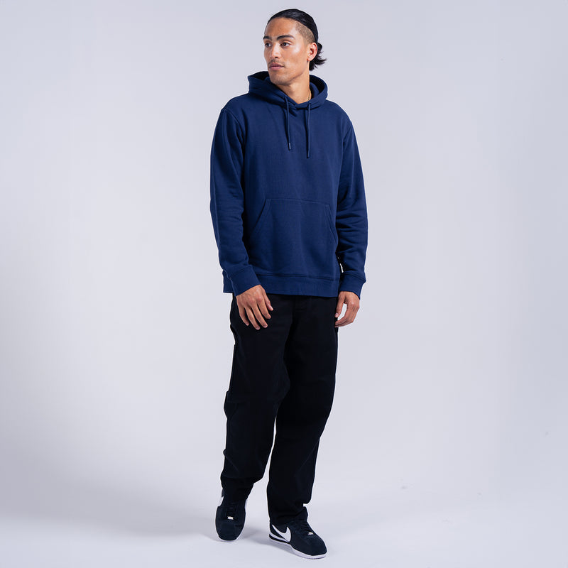Men’s navy fleece pullover hoodie on model, full-body view