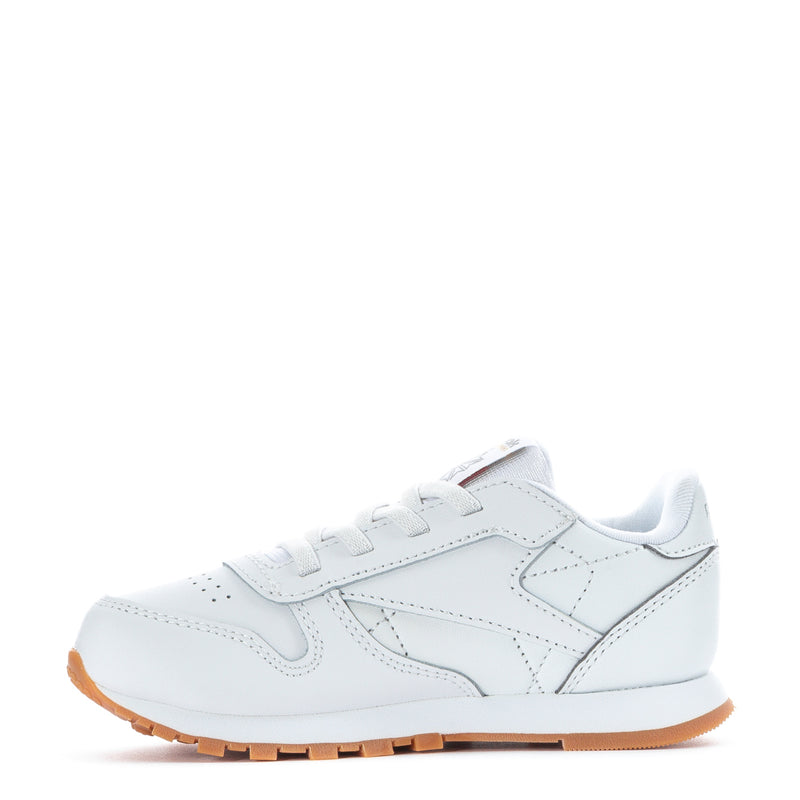 Toddler white leather sneakers, side profile with lace-up and Reebok badge.