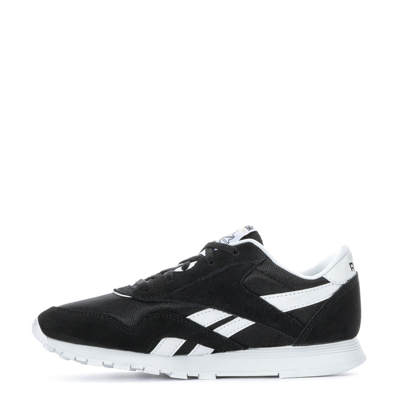 Kids' black-and-white lace-up sneakers, side profile with contrast stripes