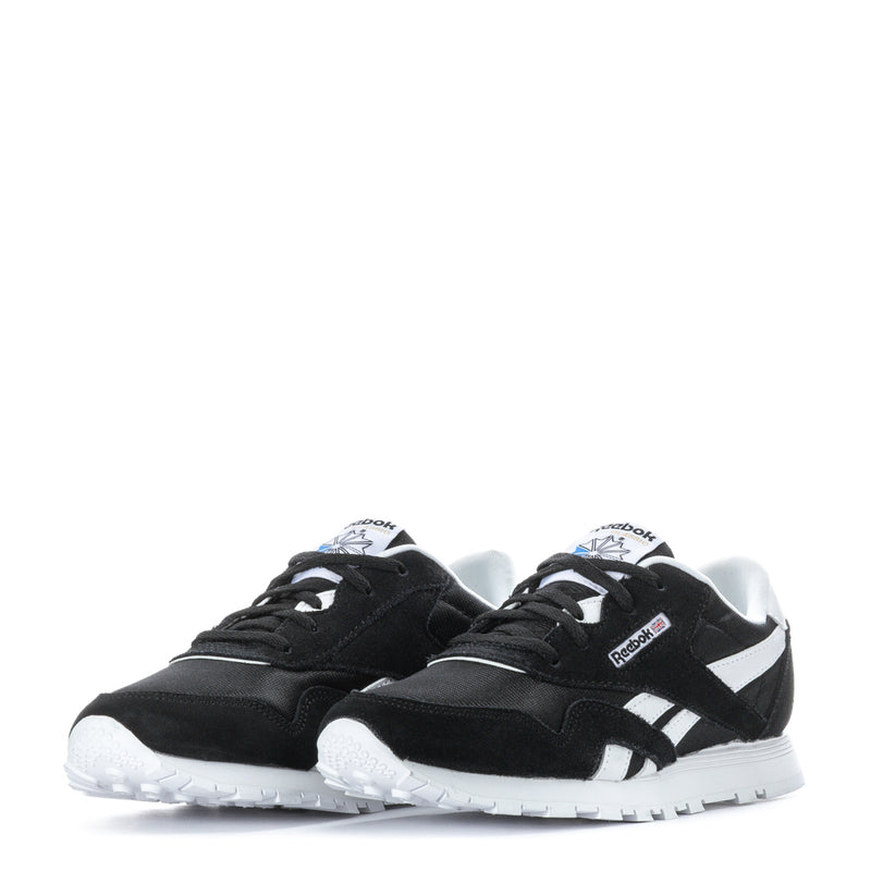 Kids' black-and-white lace-up sneakers, front view with woven toe and logo