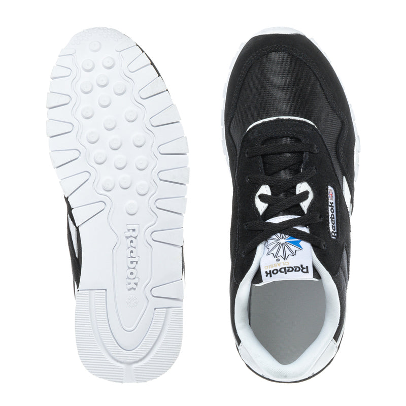 Kids' sneakers outsole and inside heel view, black upper with white sole