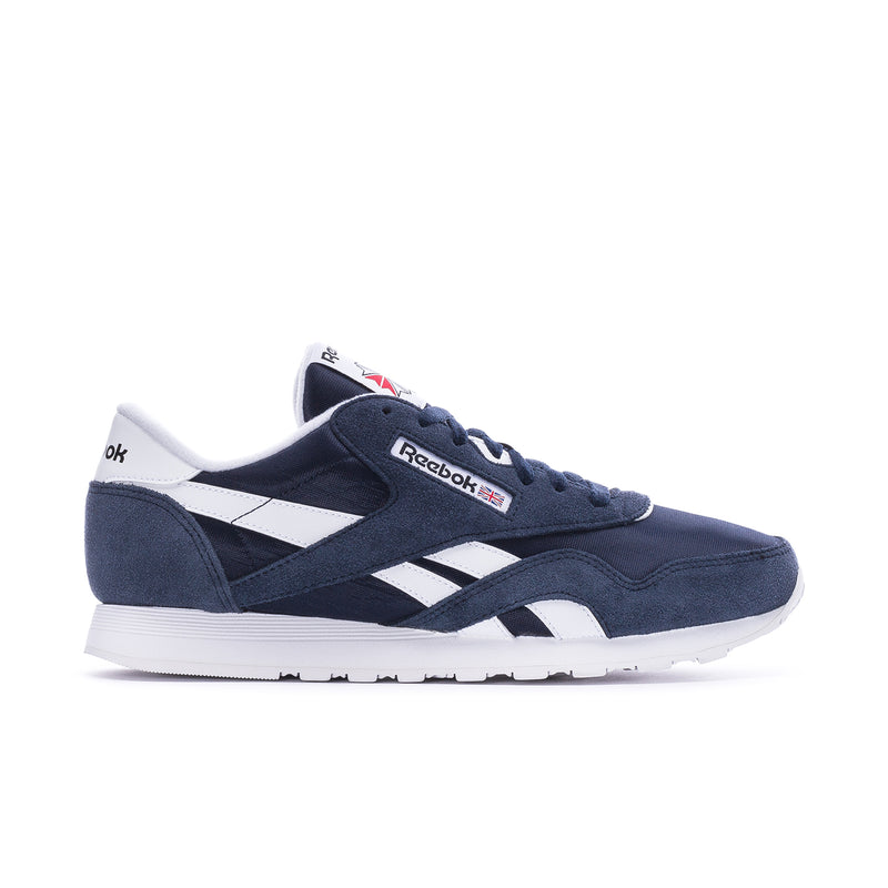 Men's navy suede-style low-top sneakers with white Reebok stripes and lace-up.