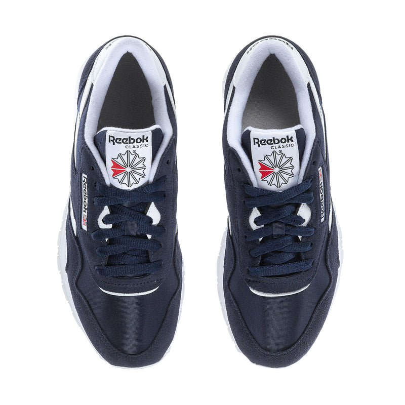 Men's navy low-top sneakers with white lining and Reebok Classics logo on tongue.