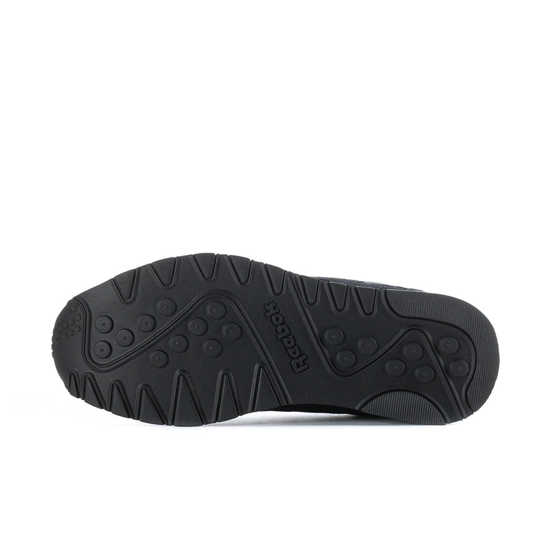 Men's black Reebok low-top sneakers, rubber outsole with tread pattern