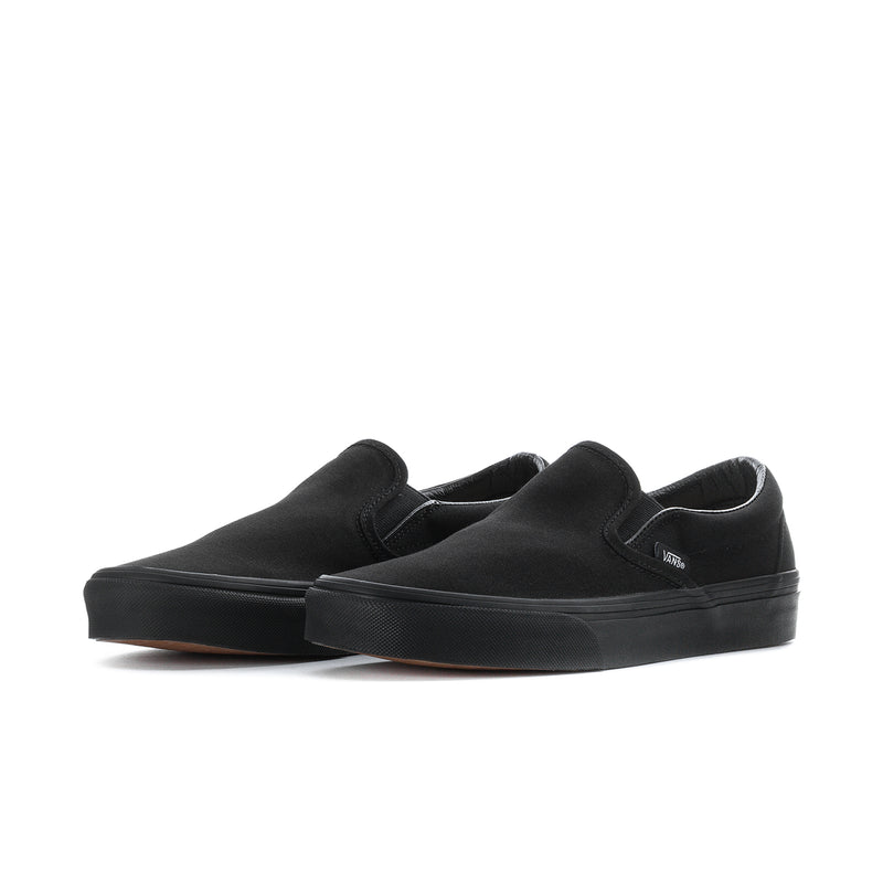 Black suede slip-on sneakers with Vans logo, low profile rubber sole