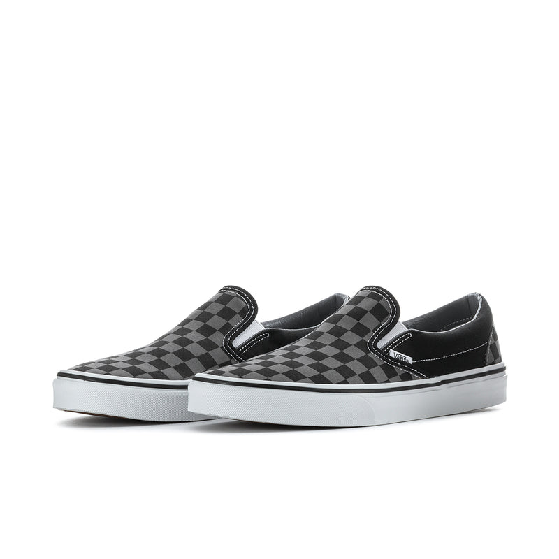 Black checkerboard slip-on sneakers with two strap-like tabs and white sole