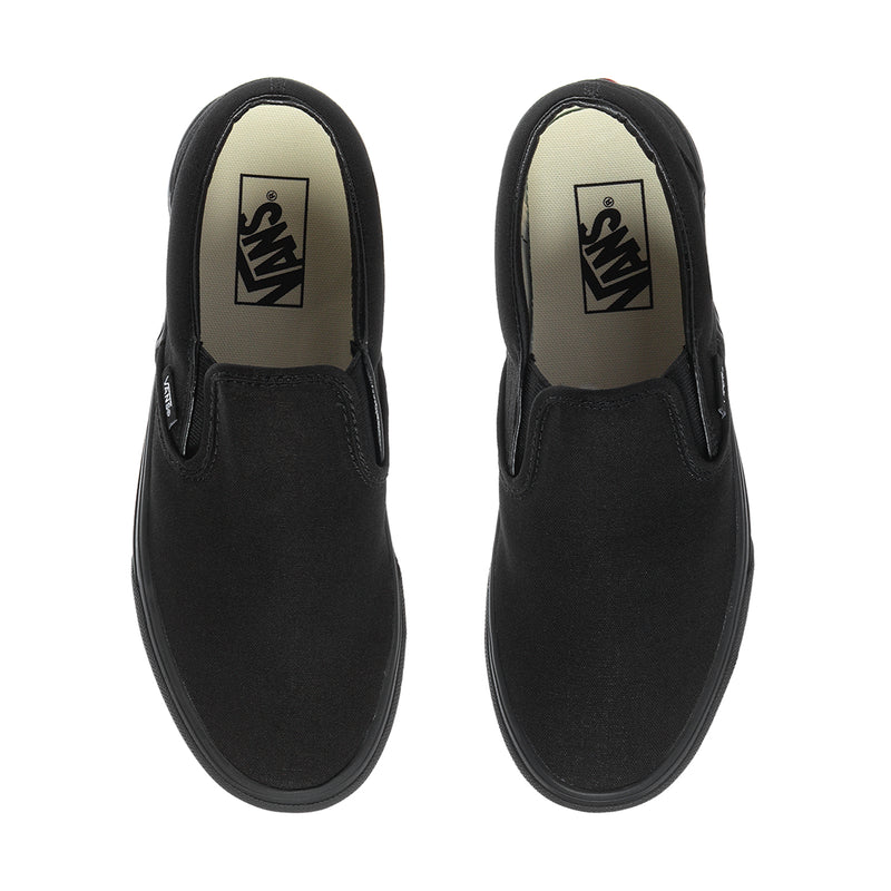 Pair of black slip-on sneakers showing inner lining with Vans label