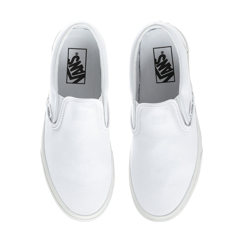 Pair of white slip-on sneakers with black VANS tongue labels and stitched panels