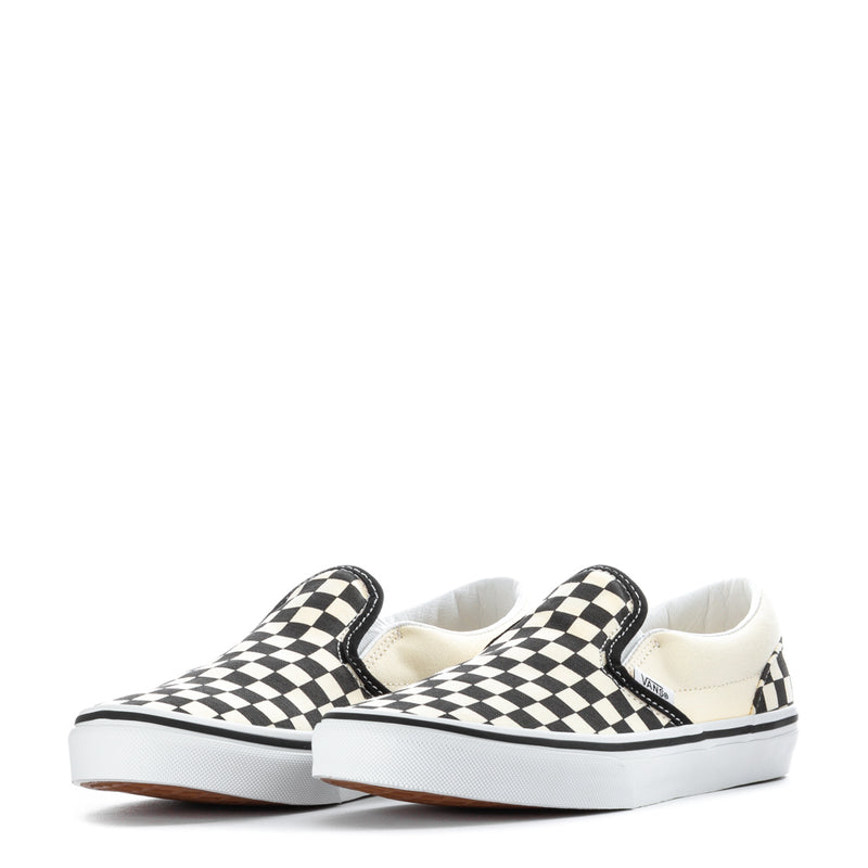 Pair of youth slip-on sneakers with black-and-white checkerboard straps and white soles