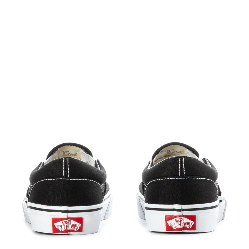 Youth Vans black slip-on sneakers, rear view with white heel trim and tags