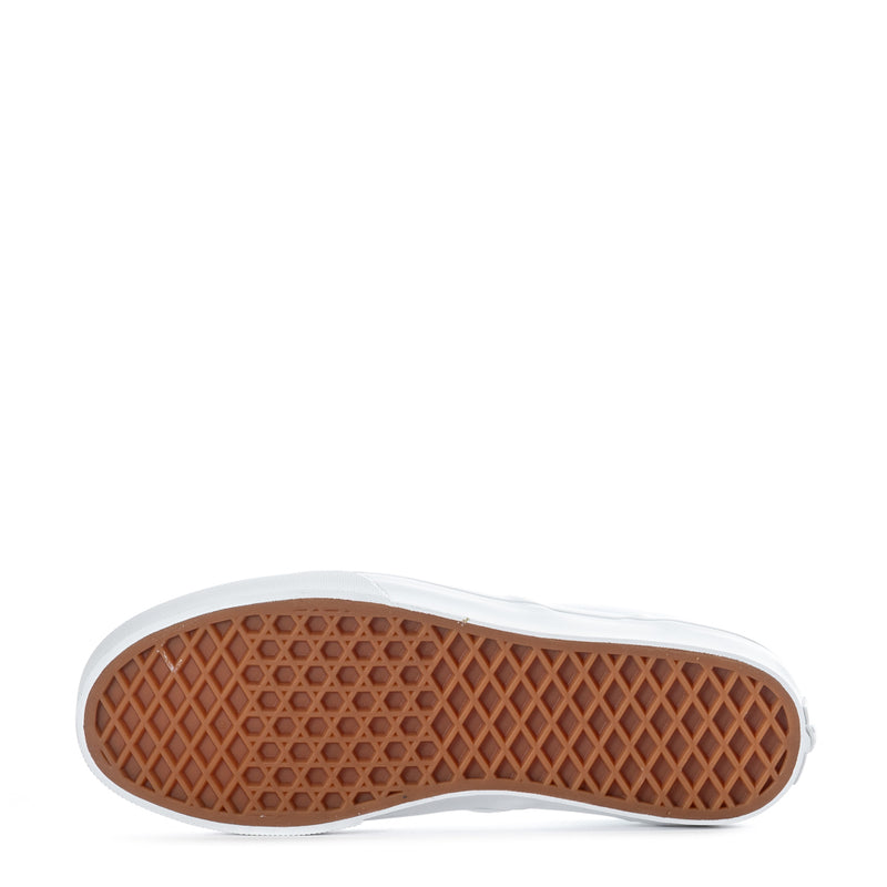 Youth white slip-on sneakers with gum rubber outsole tread