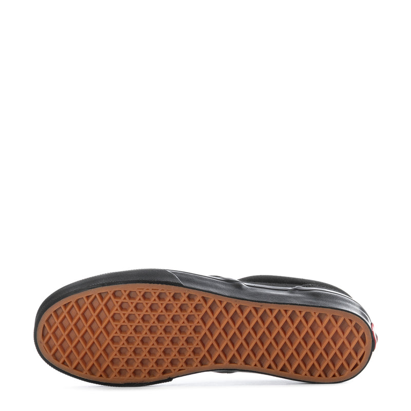 Vans youth black slip-on sneakers, outsole tread view with gum rubber