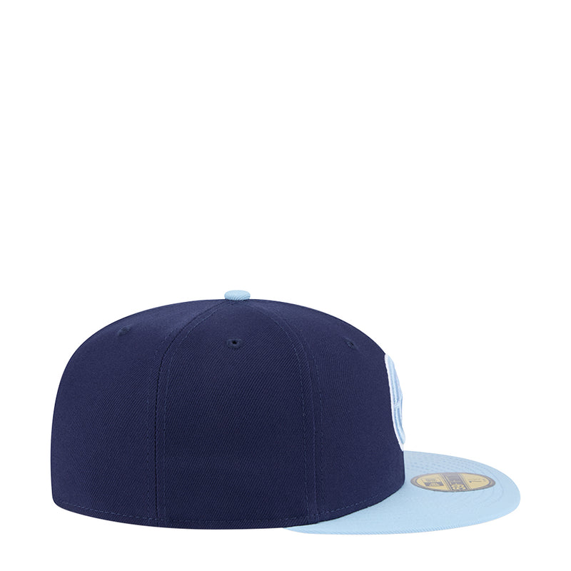 Two-tone baseball cap with navy crown and light blue brim, side view