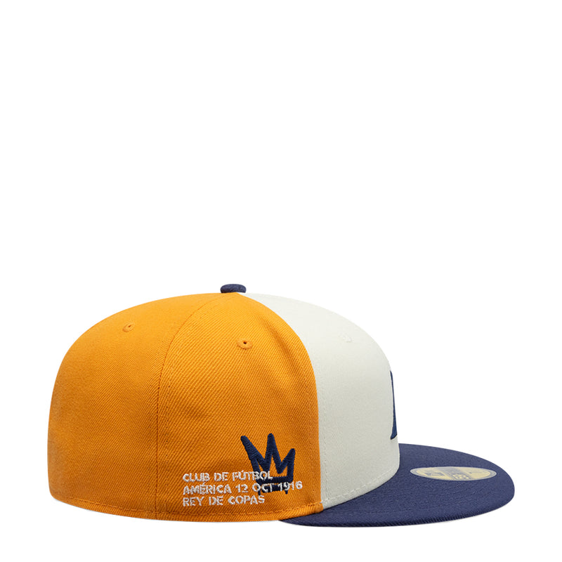 Two-tone baseball cap with orange crown, cream back panel, and navy script logo