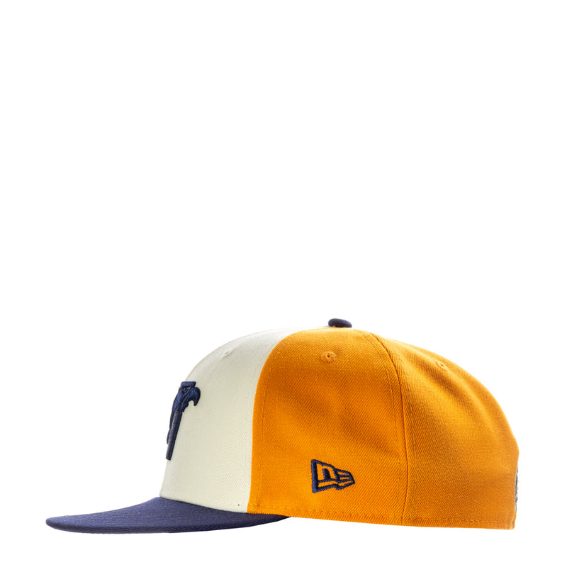 Two-tone baseball cap with orange front, cream side panels, and small navy logo