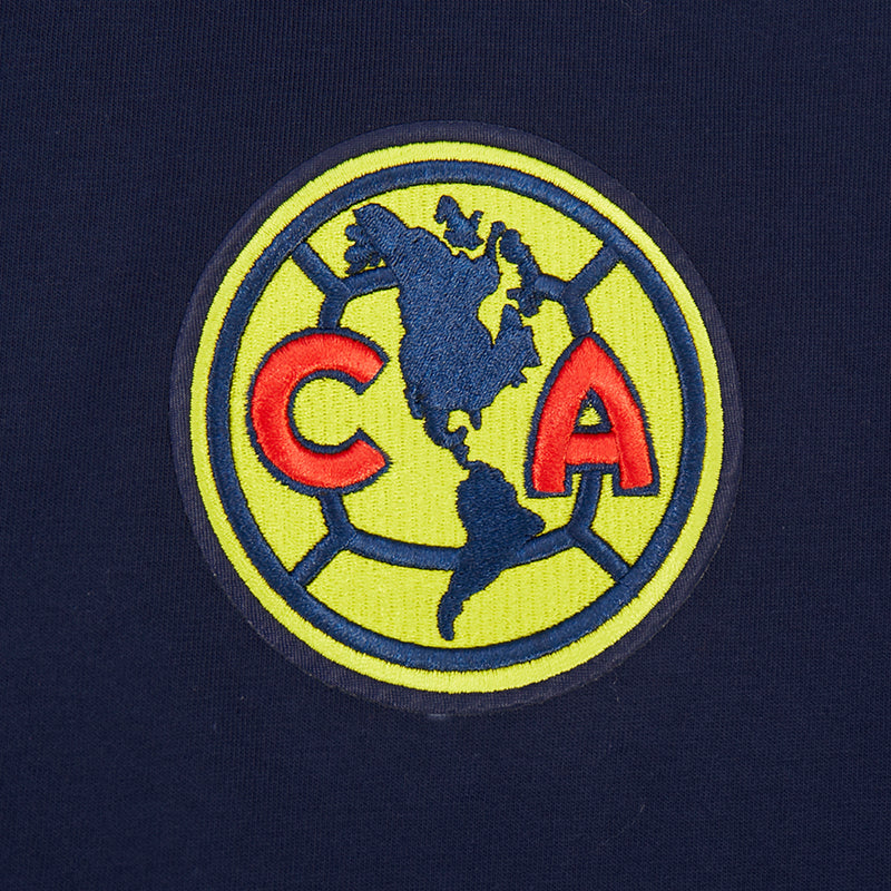Navy fabric with embroidered Club America circular crest in green, red, and yellow