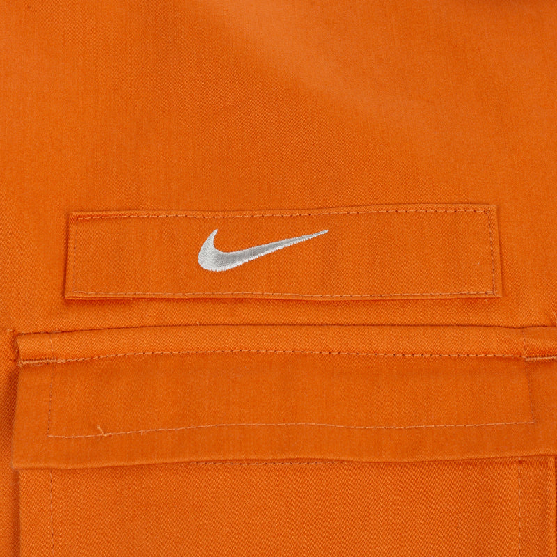 Orange woven shirt chest label with white swoosh logo