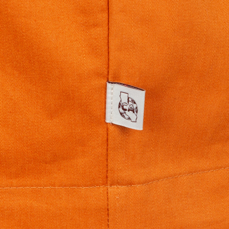 Orange woven shirt interior tag with crest logo