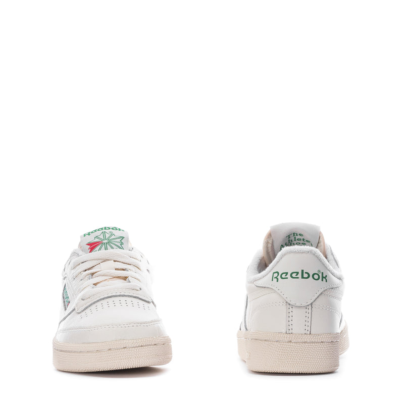 White low-top sneakers with Reebok heel logo and beige cup sole