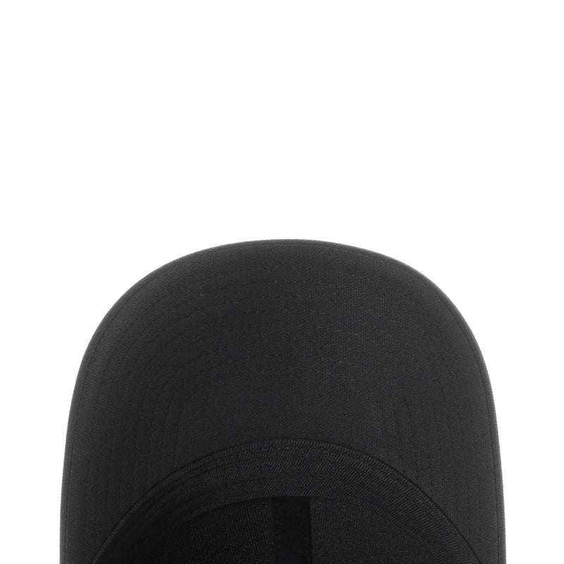 Black Nike cap crown fabric close-up with textured panel stitching