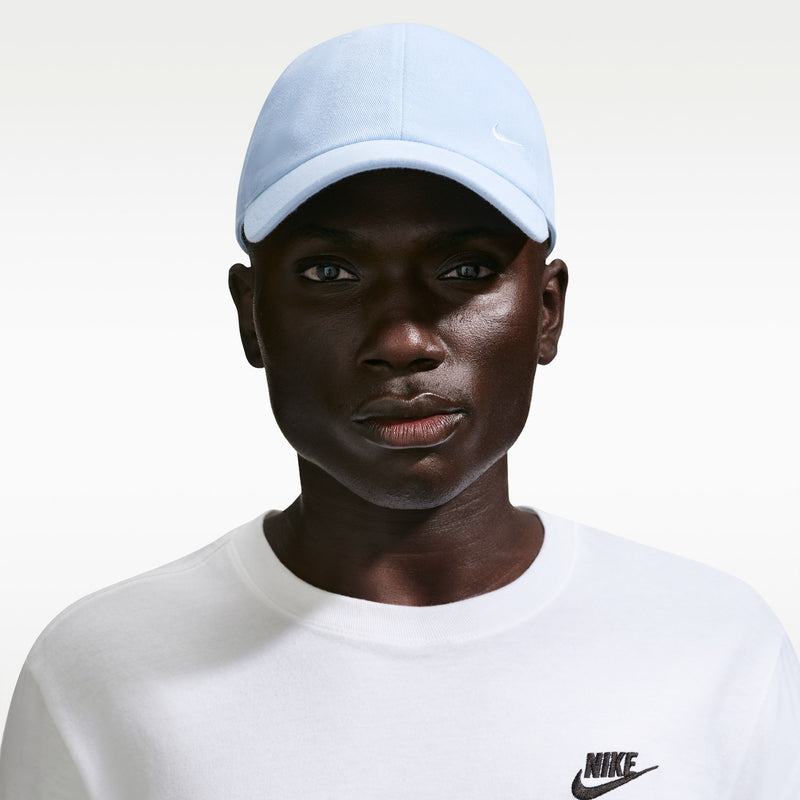 Light blue Nike cap on model with curved brim