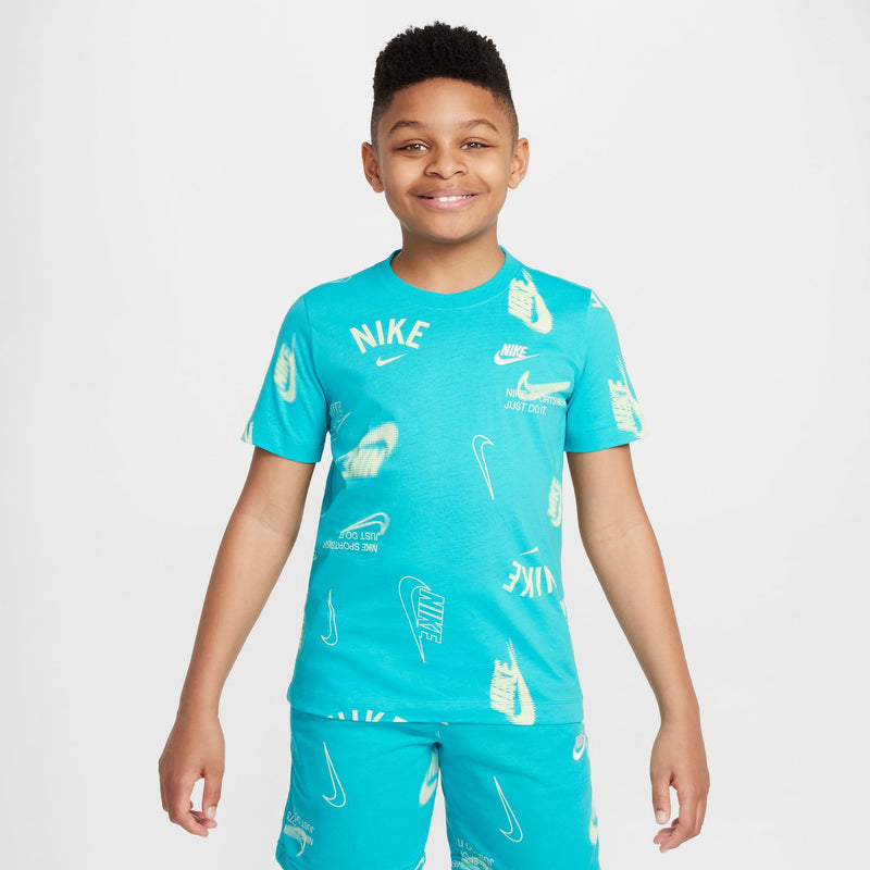 Youth turquoise tee worn by child, all-over Nike logo graphics