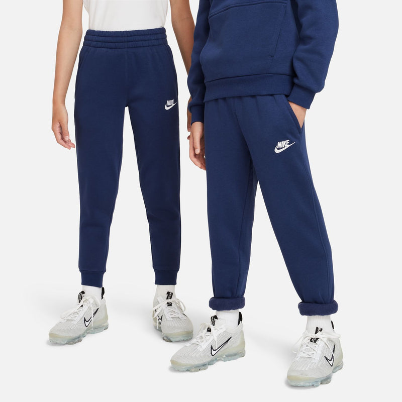 Youth fleece jogger pants in midnight navy, front view with Nike logo on thigh.