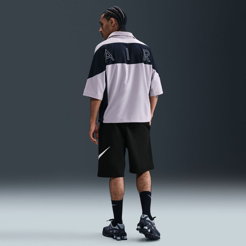 Black men's fleece shorts with white Nike swoosh on the leg