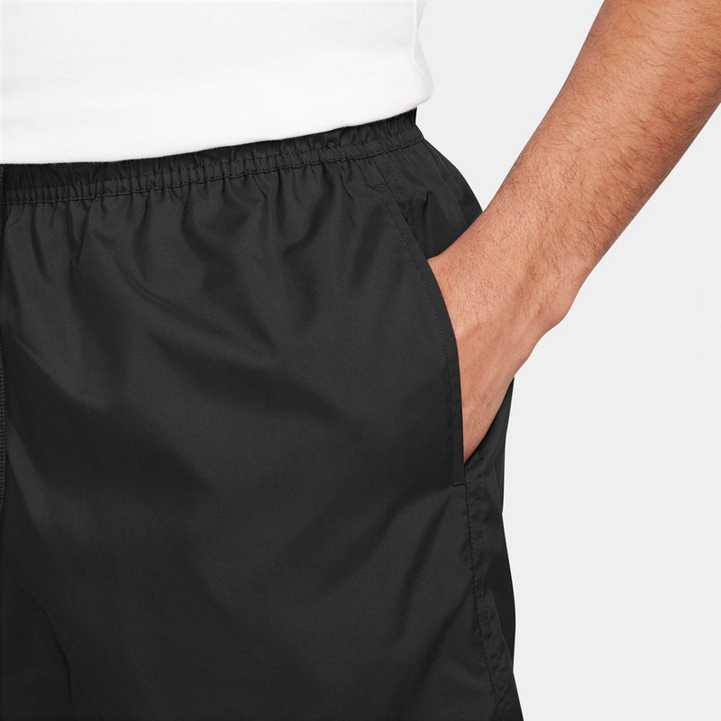 Black athletic shorts with elastic waistband and curved seam detail