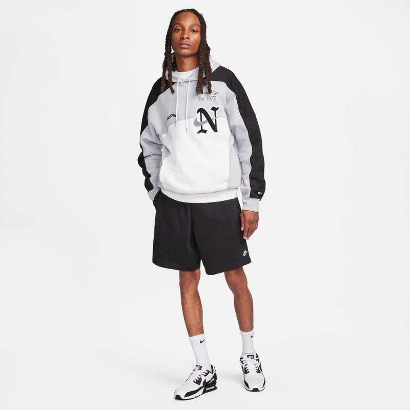 Men's black shorts with elastic waistband and drawstring, worn with sneakers