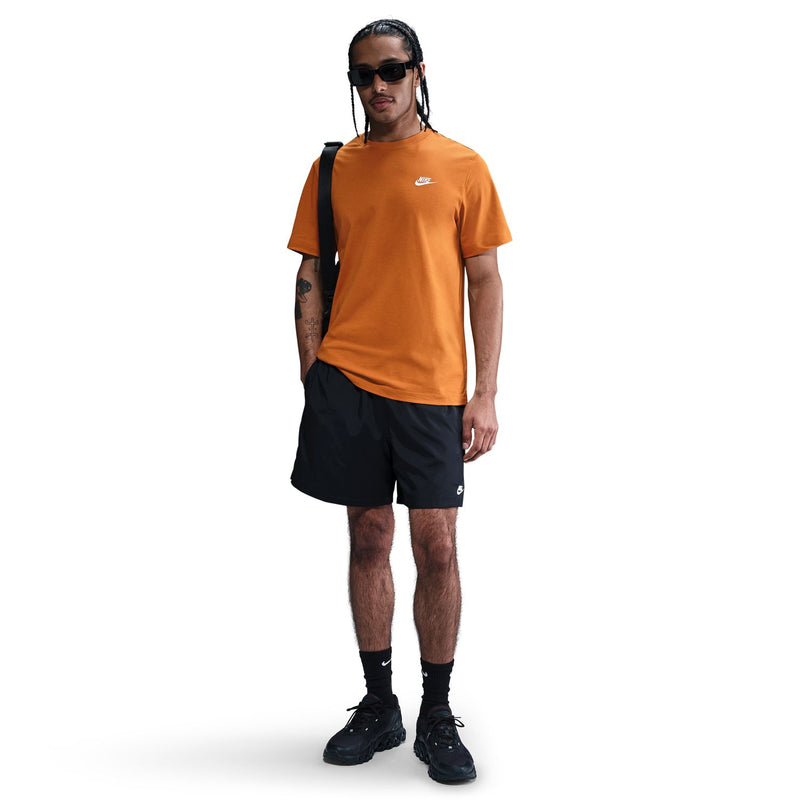 Men's orange crewneck T-shirt with Nike logo on chest, side view.