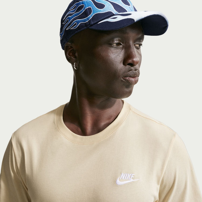 Light khaki crew-neck Nike T-shirt with small chest logo, head-to-shoulder view