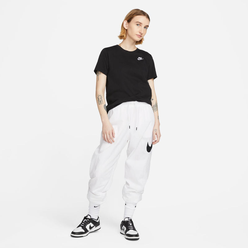 Black crewneck tee with small white Nike swoosh, worn with white pants