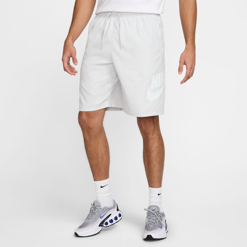 Men's white woven shorts with elastic waist, drawstring, and side pocket