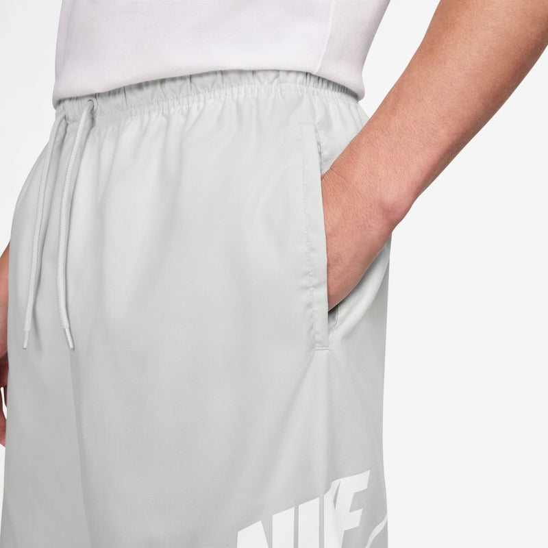 Men's white woven shorts with elastic waistband and drawstring ties