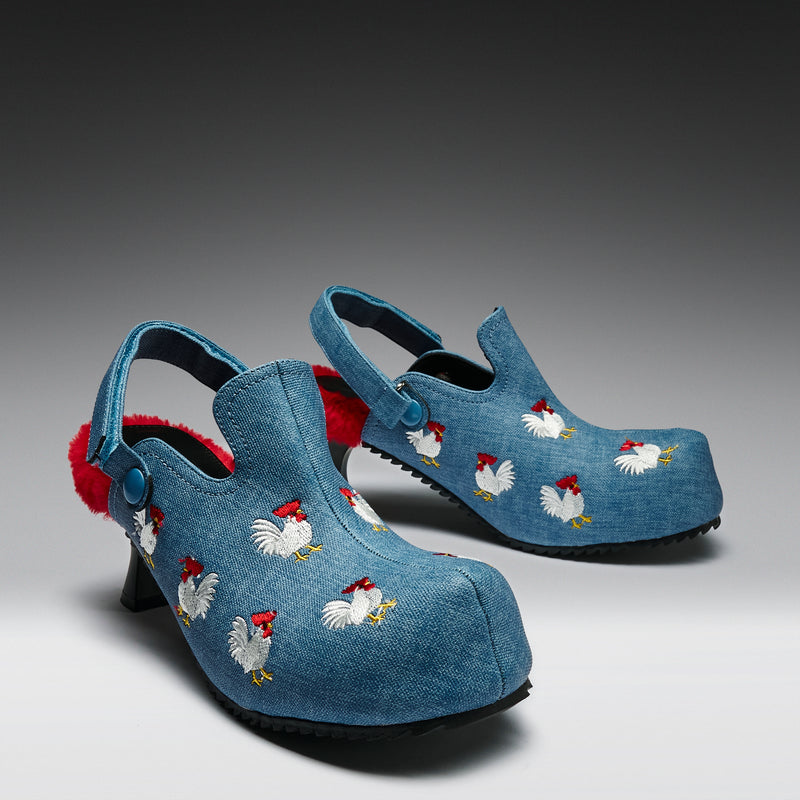 Blue clogs with chicken embroidery on a gray background