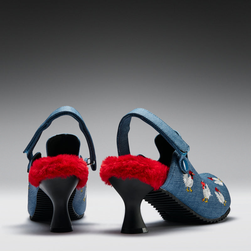 Pair of blue high-heeled shoes with red fur and chicken embroidery on a gray background
