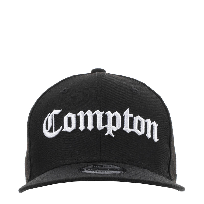 Black baseball cap with white Compton logo on the front panel and curved brim